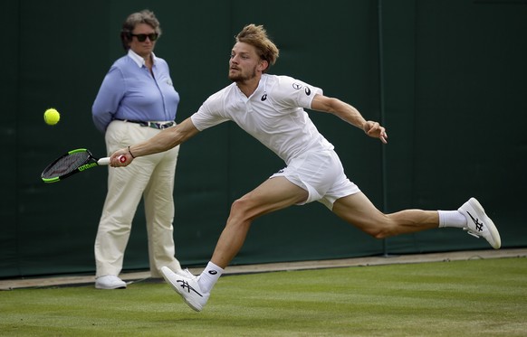 Belgium's David Goffin returns to Spain's Fernando Verdasco in Men's a singles match during day seven of the Wimbledon Tennis Championships in London, Monday, July 8, 2019. (AP Photo/Ti ...