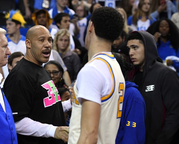 FILE - In this March 4, 2017, file photo, UCLA guard Lonzo Ball, right, shakes hands with his father LaVar following an NCAA college basketball game against Washington State in Los Angeles. UCLA won 7 ...