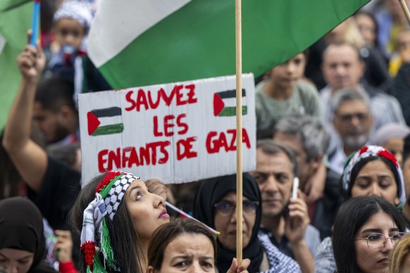 Protesters take part in a rally in support of Palestinians, in Geneva, Switzerland, Saturday, October 14, 2023. Thousands of Israelis and Palestinians have died since the militant group Hamas launched ...