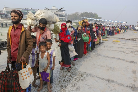 FILE - In this Feb. 15, 2021, file photo, Rohingya refugees headed to the Bhasan Char island prepare to board navy vessels from the south eastern port city of Chattogram, Bangladesh. Authorities in Ba ...