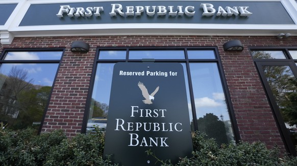 FILE - First Republic Bank signs and logos are displayed on a branch on April 26, 2023, in Wellesley, Mass. Regulators continued their search for a solution to First Republic Bank?s woes over the week ...