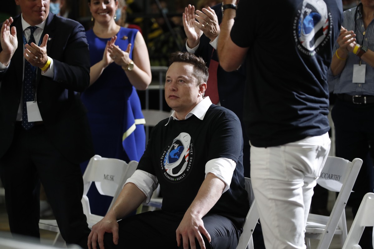 People applaud Tesla and SpaceX Chief Executive Officer Elon Musk during an event at the Vehicle Assembly Building on Saturday, May 23, 2020, at NASA's Kennedy Space Center in Cape Canaveral, Fla ...