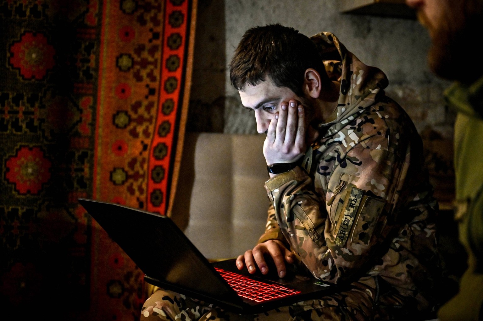 RECORD DATE NOT STATED ZAPORIZHZHIA REGION, UKRAINE - DECEMBER 24, 2023 - A soldier of the 65th Separate Mechanised Brigade serving in the Zaporizhzhia sector of the frontline uses a laptop, Zaporizhz ...