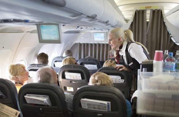 A flight attendant serves breakfast during the flight to Zurich, pictured on April 12, 2013, in an Airbus A319. The Airbus A319, an aircraft of Swiss International Air Lines, flies from Zurich to Oslo ...