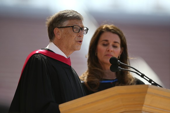 STANFORD, CA - JUNE 15: Microsoft founder and chairman Bill Gates speaks as his wife Melinda looks on during the 123rd Stanford commencement ceremony June 15, 2014 in Stanford, California. Bill Gates  ...