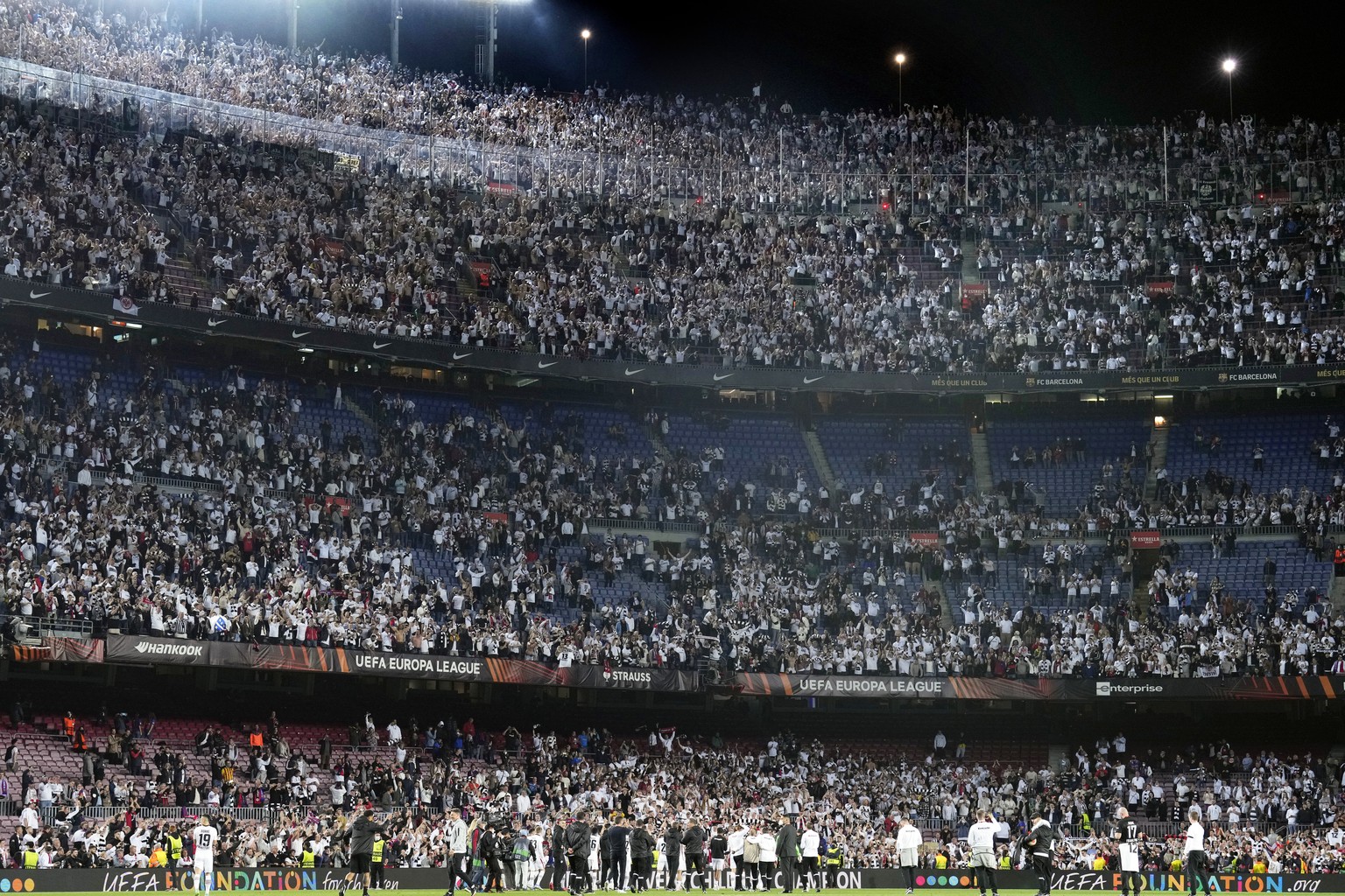 epa09890718 Eintracht Frankfurt players celebrate with supporters at the end of the UEFA Europa League quarter final, second leg soccer match between FC Barcelona and Eintracht Frankfurt in Barcelona, ...