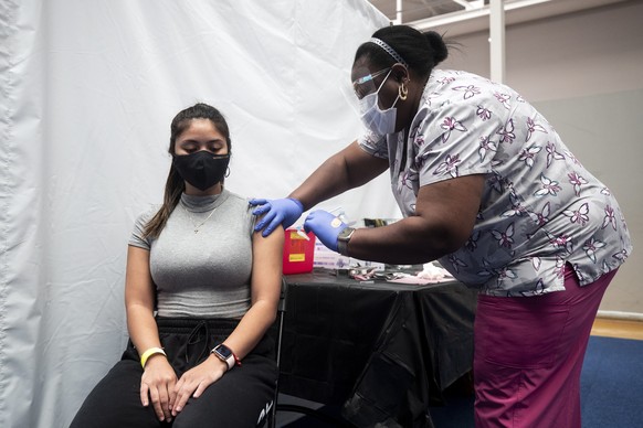 epa09062573 A student, Michaela, is vaccinated against Covid-19, at the Loyal Marymount University during a vaccination campaign organized by the Department of Catholic Schools of the Archdiocese of L ...