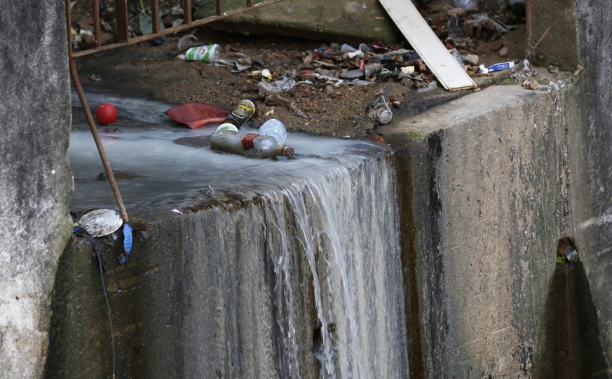 epa05495195 A general view shows garbage, waste water and raw sewage, among the many waterfalls and channels that run openly next to the crowded dwellings in Rocinha Favela, threatening the health of  ...