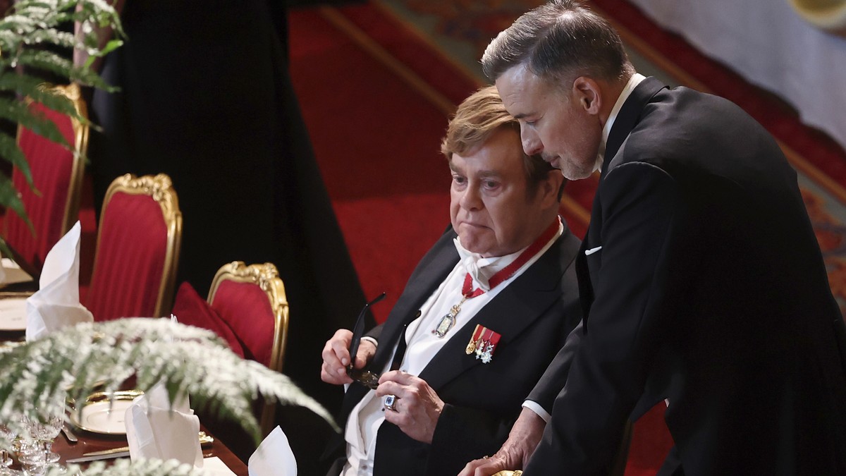 Elton John, left, and David Furnish attend the State Banquet for the President of France Emmanuel Macron, and his wife Brigitte Macron, at Windsor Castle, in Windsor, England, Tuesday, July 8, 2025. ( ...