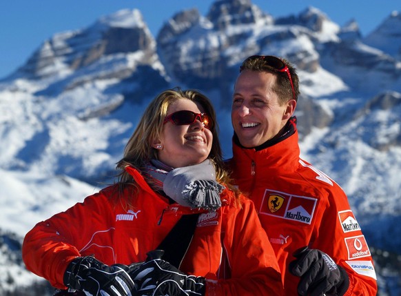 epa07258291 (FILE) German seven time Formula 1 champion Michael Schumacher (R, team Ferrari) and his wife Corinna smile in front of a mountain panorama in the ski resort of Madonna di Campiglio, Italy ...