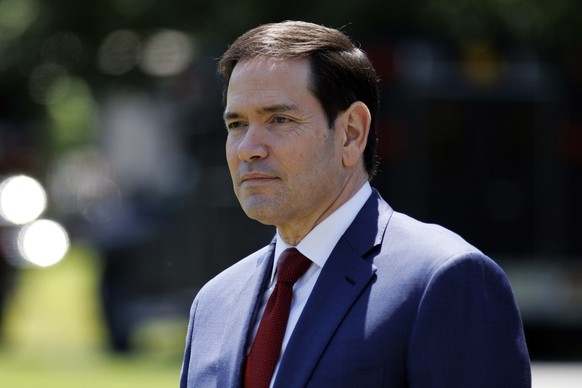 epa12951304 US Secretary of State Marco Rubio watches as US President Donald Trump talks to the media before leaving the South Lawn of the White House, Washington, DC, USA, 12 May 2026. President Trum ...