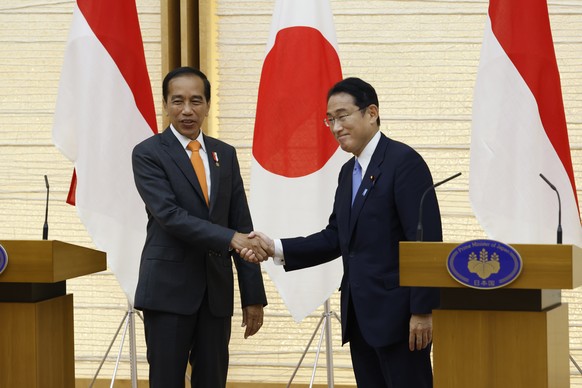 Indonesian President Joko Widodo, left, and Japan&#039;s Prime Minister Fumio Kishida shake hands as they conclude a joint news conference at the prime minister&#039;s official residence in Tokyo Wedn ...