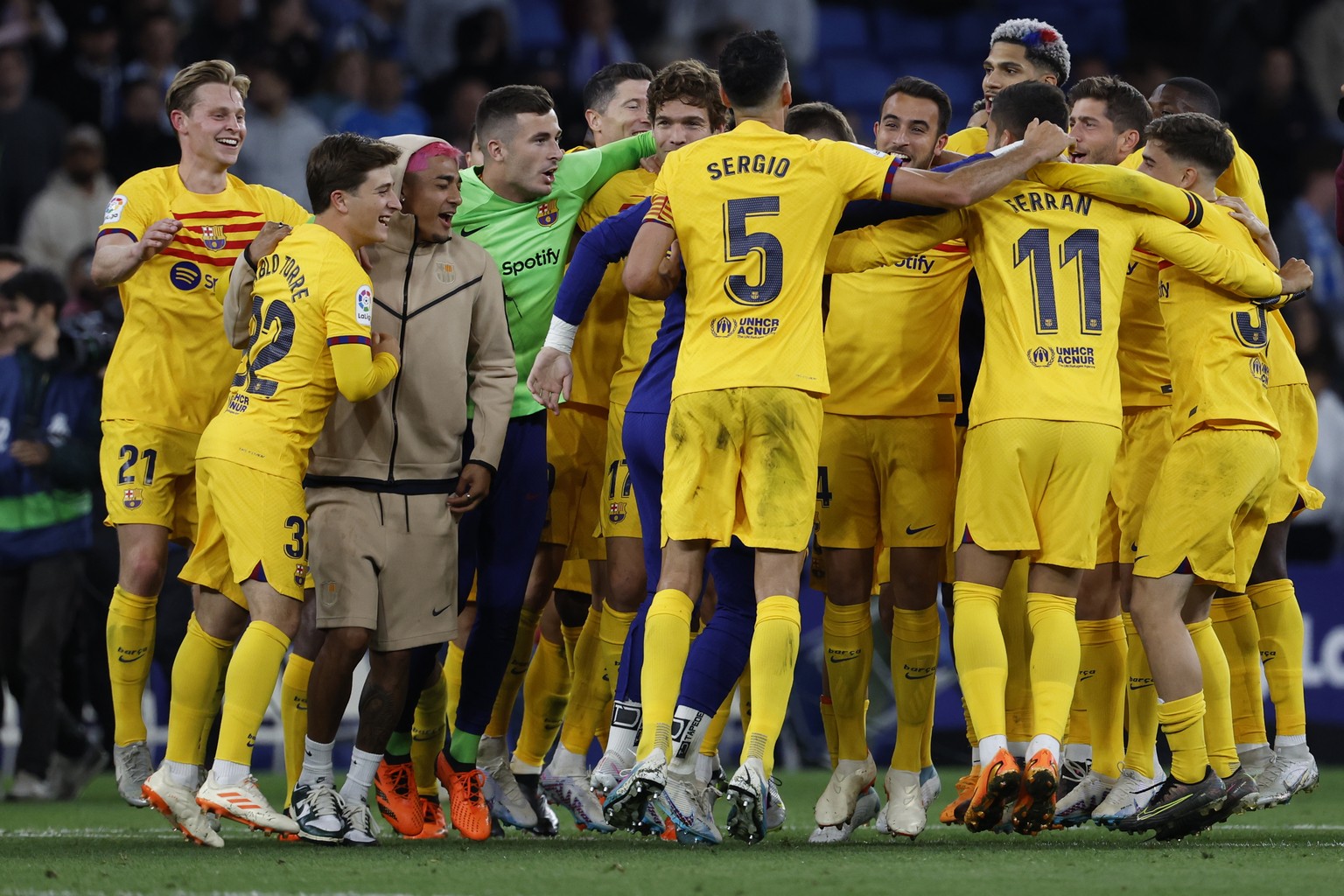 Barcelona players celebrate after the Spanish La Liga soccer match between Espanyol and Barcelona at the RCDE stadium in Barcelona, Sunday, May 14, 2023. (AP Photo/Joan Monfort)