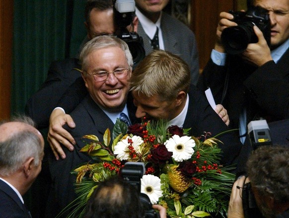Newly elected Federal Councillor Christoph Blocher, left, is hugged by National Councillor Toni Brunner after his election during the session of the United General Assembly in Bern, Switzerland, Wedne ...
