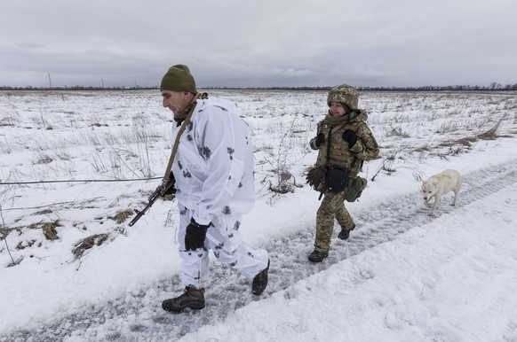 Ukrainian soldiers walk at the line of separation from pro-Russian rebels, Donetsk region, Ukraine, Sunday, Jan. 2, 2022. President Joe Biden has warned Russia&#039;s Vladimir Putin that the U.S. coul ...