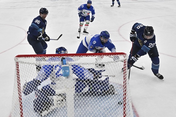 Finland's Sebastian Aho (20) scores his team's first goal during a preliminary round game of men's ice hockey between Finland and Italy at the 2026 Winter Olympics, in Milan, Italy, Sat ...