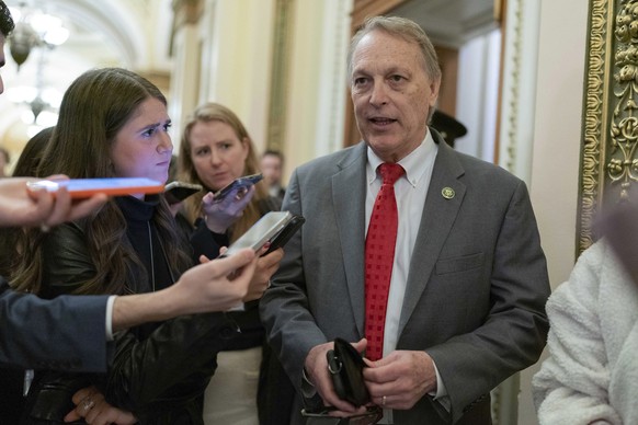 Representative Andy Biggs, R-Ariz., talks to reporters as he leaves the House chamber as a second-day vote goes on to elect a speaker and convene the 118th Congress in Washington, Jan.  ...