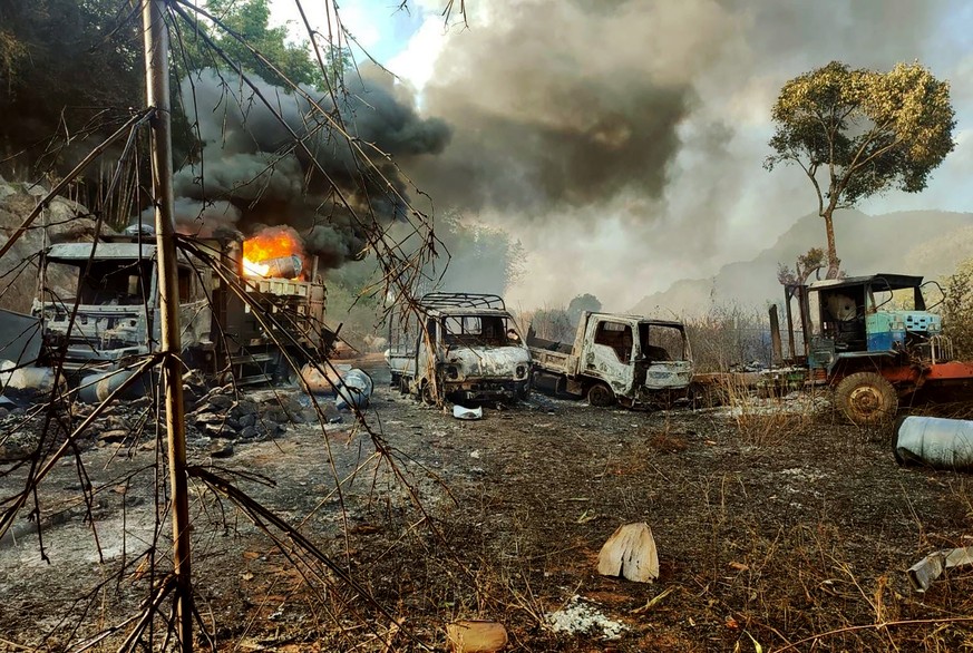 In this photo provided by the Karenni Nationalities Defense Force (KNDF), smokes and flames billow from vehicles in Hpruso township, Kayah state, Myanmar, Friday, Dec. 24, 2021. Myanmar government tro ...