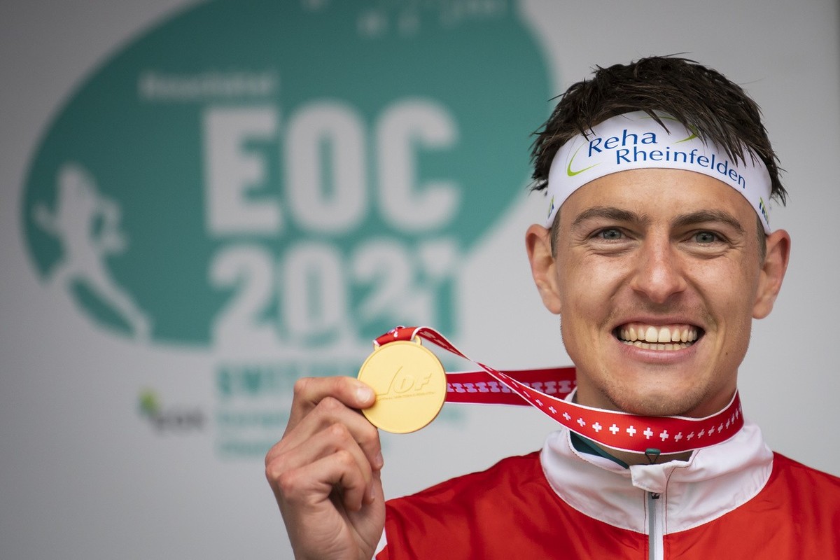 The winner Matthias Kyburz of Switzerland celebrates with the gold medal on the podium during the men's KO-Sprint final race at the European Orienteering Championships in Neuchatel, Switzerland,  ...