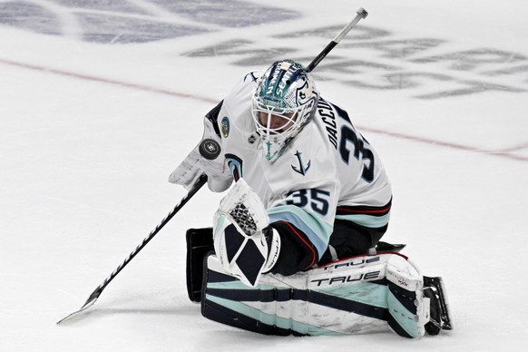 Seattle Kraken goaltender Joey Daccord (35) controls the puck against the Anaheim Ducks during the third period of an NHL hockey game in Anaheim, Calif., Monday, Nov. 25, 2024. (AP Photo/Alex Gallardo ...
