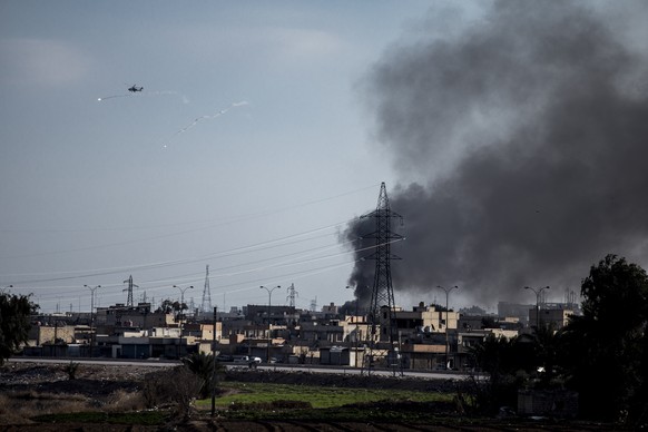 FILE - US attack helicopter shoots flares in Hassakeh, northeast Syria, Wednesday, Jan. 26, 2022. With a spectacular jail break in Syria and a deadly attack on an army barracks in Iraq, the Islamic St ...