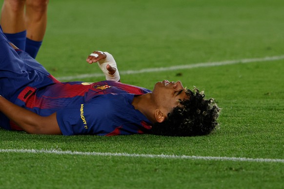 Barcelona's Lamine Yamal lies on the pitch injured during the Spanish La Liga soccer match between Barcelona and Celta Vigo in Barcelona, Spain, Wednesday, April 22, 2026. (AP Photo/Joan Monfort) ...