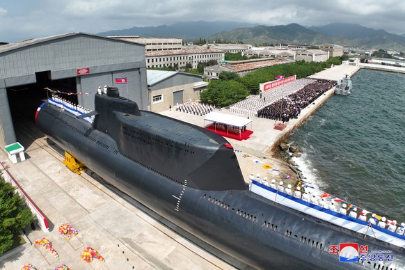 epa10847725 A photo released by the official North Korean Central News Agency (KCNA) shows a launching ceremony for what is said to be a tactical nuclear-armed submarine, designated No. 841 or Hero Ki ...