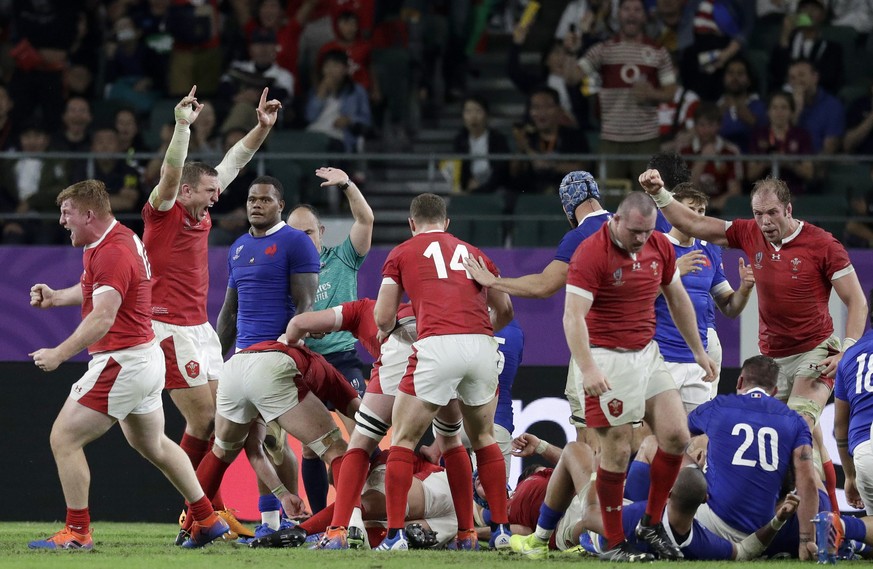 Wales players react after Wales&#039; Ross Moriarty scores a try during the Rugby World Cup quarterfinal match at Oita Stadium between Wales and France in Oita, Japan, Sunday, Oct. 20, 2019. (AP Photo ...