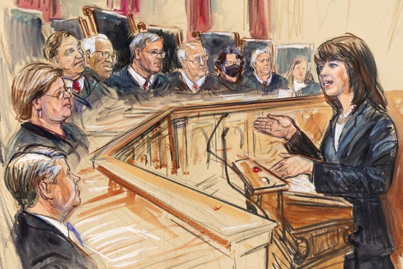 This artist sketch depicts Solicitor General Elizabeth Prelogar, right, presenting an argument before the Supreme Court, Monday, Nov. 1, 2021, in Washington. Justices seated from left are Associate Ju ...