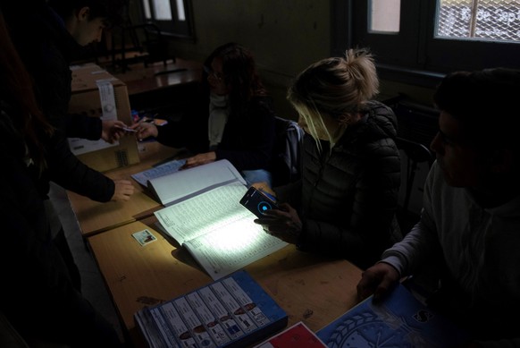 epa07652552 People vote in Governor elections among a power outage in Rosario, Santa Fe province, Argentina, 16 June 2019. A massive power failure has left Argentina and Uruguay entirely without acces ...