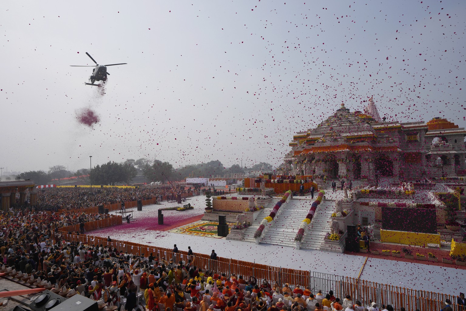An Indian Air Force helicopter showers flower petals during the opening of a temple dedicated to Hinduism?s Lord Ram in Ayodhya, India, Monday, Jan. 22, 2024. Indian Prime Minister Narendra Modi opene ...