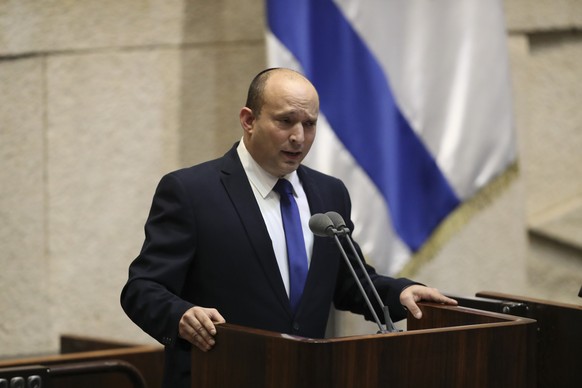 Israel's designated new prime minister, Naftali Bennett speaks during a Knesset session in Jerusalem Sunday, June 13, 2021. Bennett is expected later Sunday to be sworn in as the country's new prime m ...