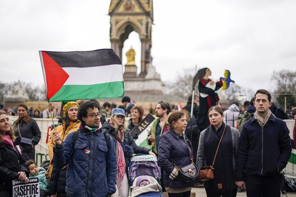 Protesters hold up flags and banners during a demonstration in support of the Palestinian people in Gaza, in London, Saturday, February 17, 2024. (AP Photo/Alberto Pezzali)