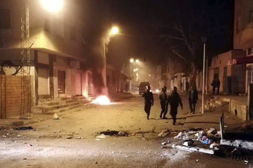 Tunisian Police officers patrol after clashes in the streets of Kasserine, southern of Tunisia, Tuesday, Dec 25, 2018.The death of a Tunisian journalist Abderrak Zorgui who set himself on fire to prot ...