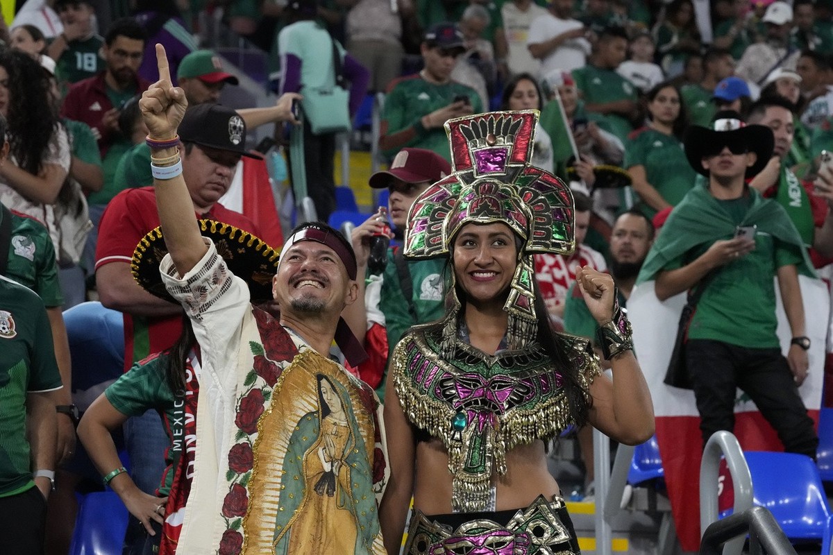 Mexican fans wait for the start of the World Cup group C soccer match between Mexico and Poland, at the Stadium 974 in Doha, Qatar, Tuesday, Nov. 22, 2022. (AP Photo/Aijaz Rahi)