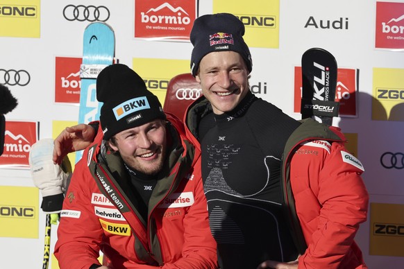 Switzerland&#039;s Alexis Monney poses with teammate Marco Odermatt after completing an alpine ski, men&#039;s World Cup downhill race, in Bormio, Italy, Saturday, Dec. 28, 2024. (AP Photo/Marco Trova ...