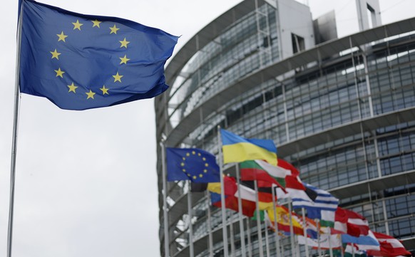 The European flag, left, flies Tuesday, April 18, 2023 at the European Parliament in Strasbourg, eastern France. (AP Photo/Jean-Francois Badias)