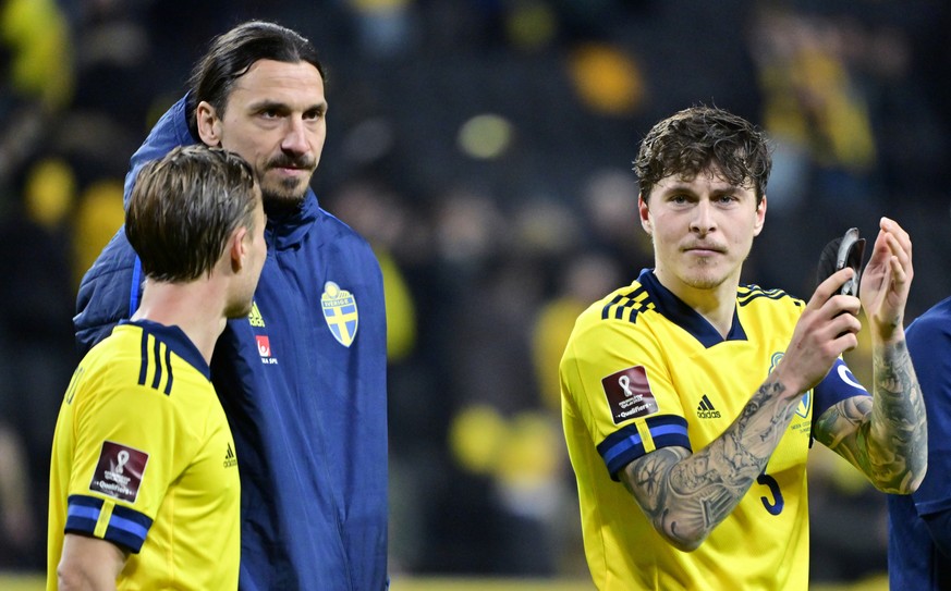 Sweden&#039;s Zlatan Ibrahimovic, second left, celebrates Sweden&#039;s victory with Victor Nilsson Lindelöf, right, after the group B World Cup 2022 qualifying playoff soccer match between Sweden and ...