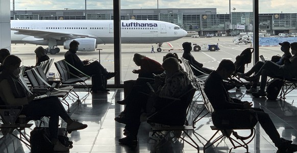 FILE -Passengers wait for their Lufthansa flight at the airport in Frankfurt, Germany, Saturday, May 15, 2021. The number of air passengers in Germany rebounded somewhat in 2021, but was still over tw ...