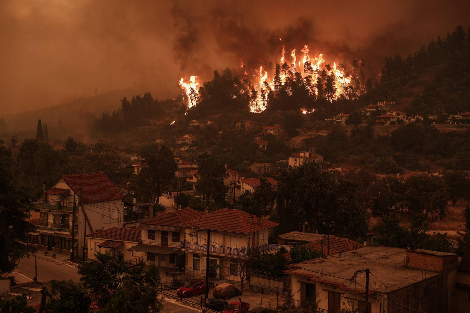 August 8, 2021, Evia island, Greece: Flames approaching at Gouves village on the island of Evia, about 185 kilometers 115 miles north of Athens, Greece, Sunday, Aug. 8, 2021. Pillars of billowing smok ...