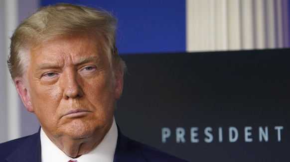 FILE - In this Friday, Nov. 20, 2020 file photo, President Donald Trump listens during an event in the briefing room of the White House in Washington. A federal judge in Pennsylvania says he won