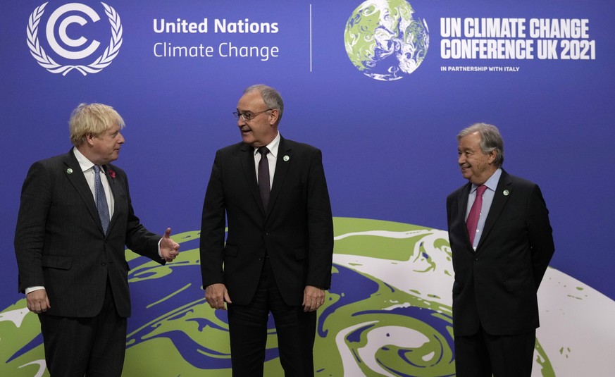 British Prime Minister Boris Johnson, left, and United Nations Secretary General Antonio Guterres, right, greet Switzerland&#039;s President Guy Parmelin during arrivals at the COP26 U.N. Climate Summ ...