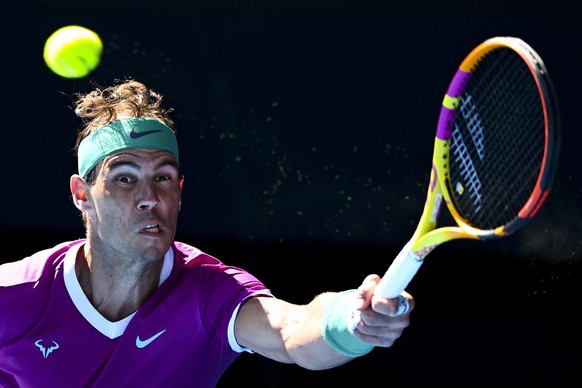 epa09690498 Rafael Nadal of Spain returns to Marcos Giron of the United States in their first round match on Day 1 of the Australian Open tennis tournament, at Melbourne Park, in Melbourne, Australia, ...