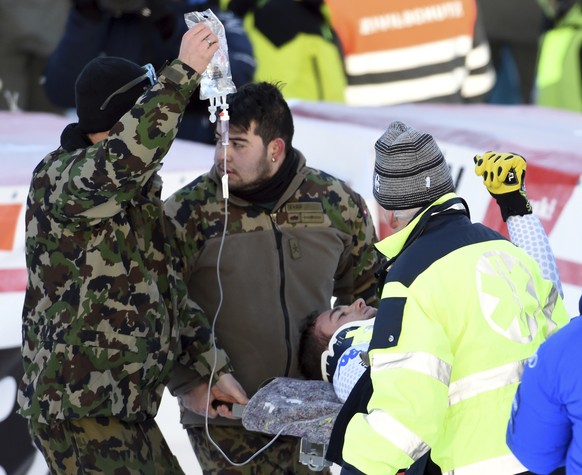 Italy&#039;s Emanuele Buzzi is carried away in a stretcher after crashing in the finish area of an alpine ski, men&#039;s World Cup downhill in Wengen, Switzerland, Saturday, Jan. 19, 2019. (AP Photo/ ...