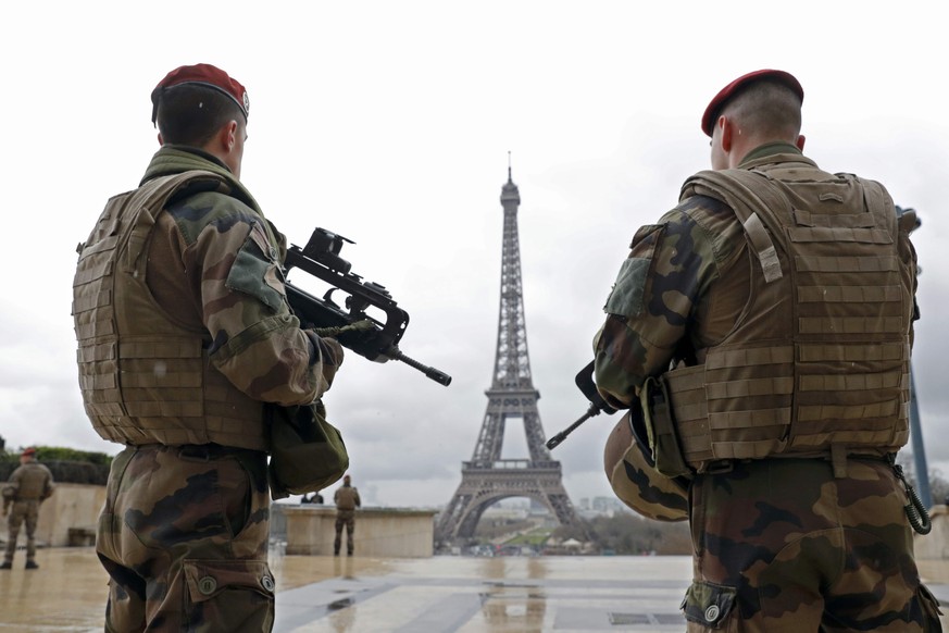 French army paratroopers patrol near the Eiffel Tower in Paris, France, in this picture taken on March 30, 2016. The French government will propose extending the country&#039;s state of emergency unti ...