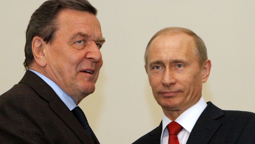 FILE In this April 14, 2009 file photo then Russian Prime Minister Vladimir Putin, right, and former German chancellor Gerhard Schroeder seen during their meeting in St. Petersburg, Russia. Germany’s  ...