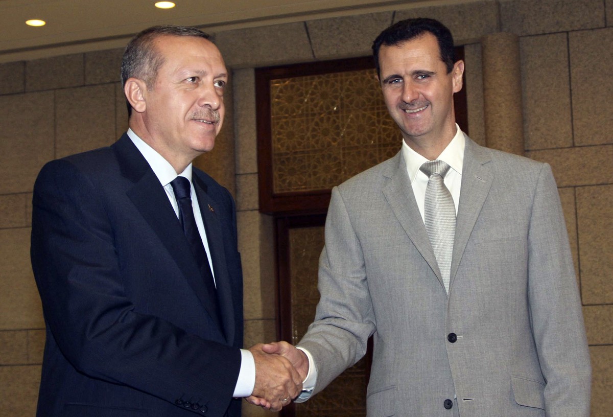 FILE - Syrian President Bashar Assad, right, shakes hands with Turkish Prime Minister Recep Tayyip Erdogan, left, at al-Shaab presidential palace in Damascus, Syria, Monday Oct. 11, 2010. Turkish Pres ...