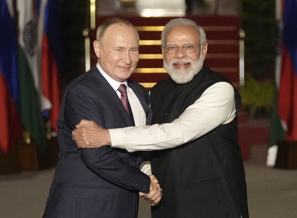 FILE - Russian President Vladimir Putin, left, and Indian Prime Minister Narendra Modi greet each other before their meeting in New Delhi, India on Dec. 6, 2021. India on Thursday said it would ramp u ...