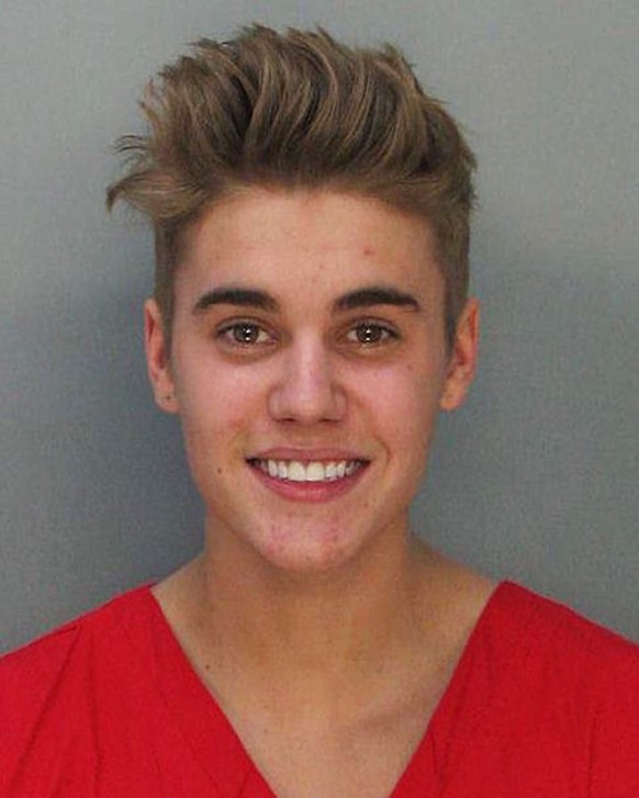 This police booking mug made available by the Miami Dade County Corrections Department shows pop star Justin Bieber, Thursday, Jan. 23, 2014. Bieber and singer Khalil were arrested for allegedly drag- ...