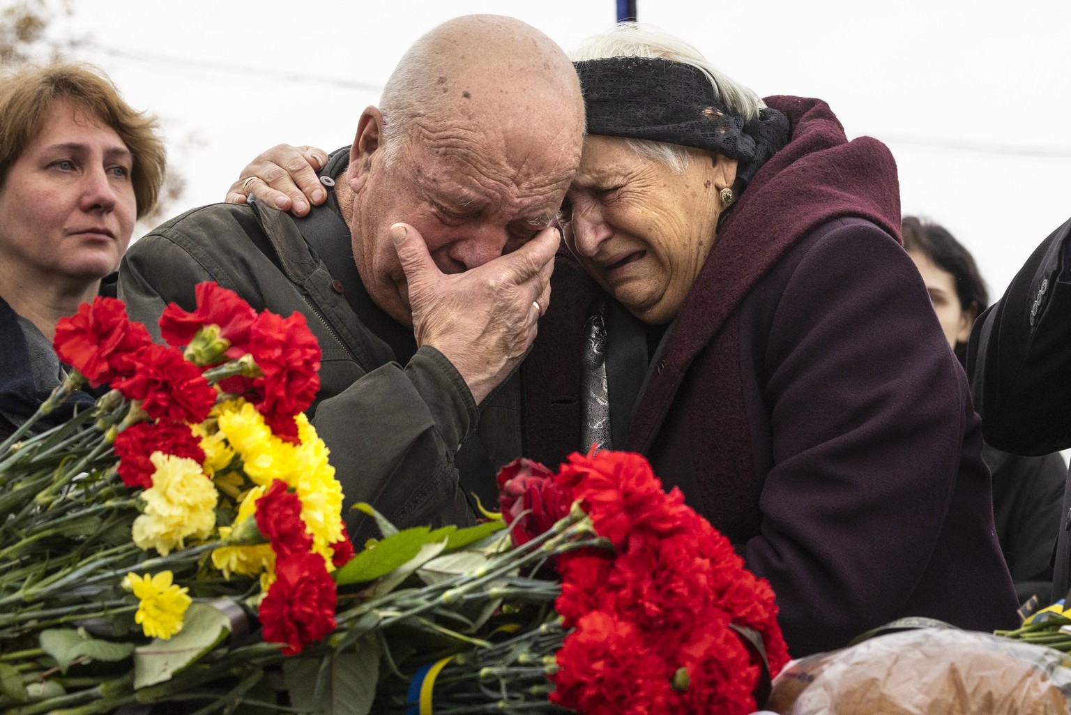 Mykola Grishenko and his wife Olga Grishenko mourn during military funeral ceremonies honoring Yuriy Grishenko who was killed on September 27 in the Luhansk region of Kiev, Ukraine, on October 25, 2022. 